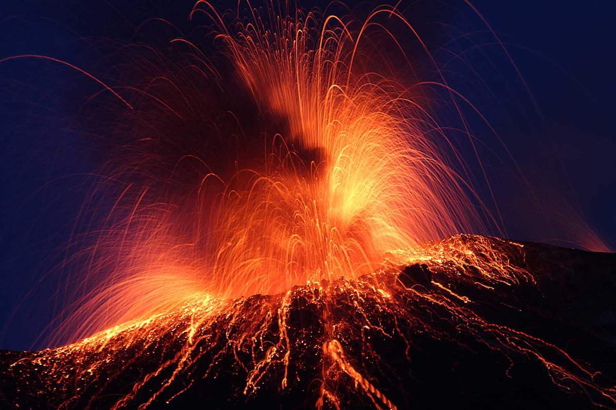 Night eruption volcano Stromboli Glowing rocks falling down
