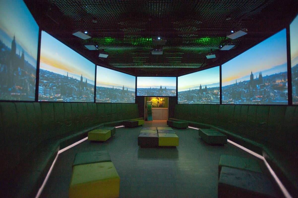 A dark room with interactive display videos all around
