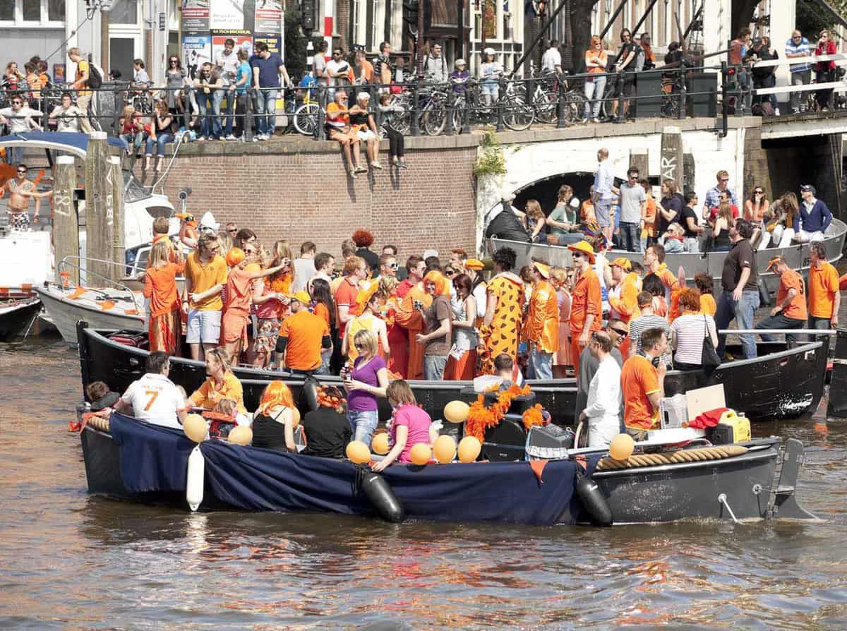 groups of people on the standing on boats in the city