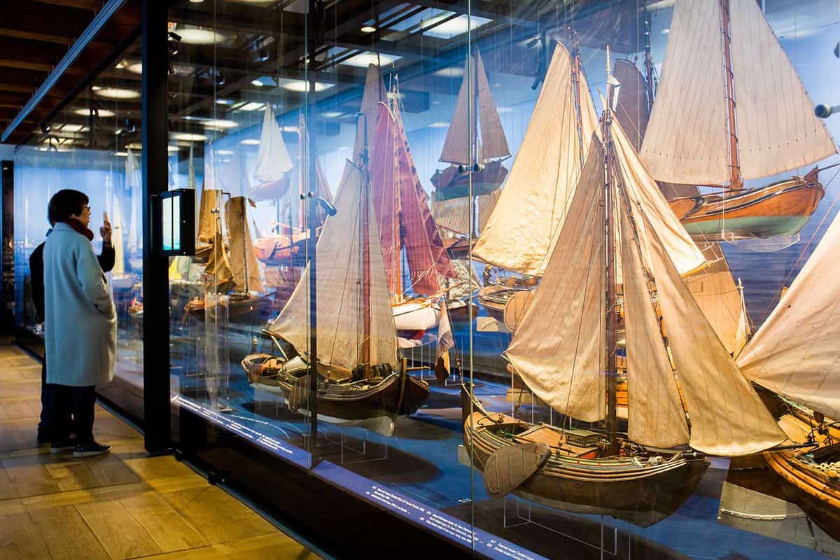 Interior display gallery showing model ships in glass cases