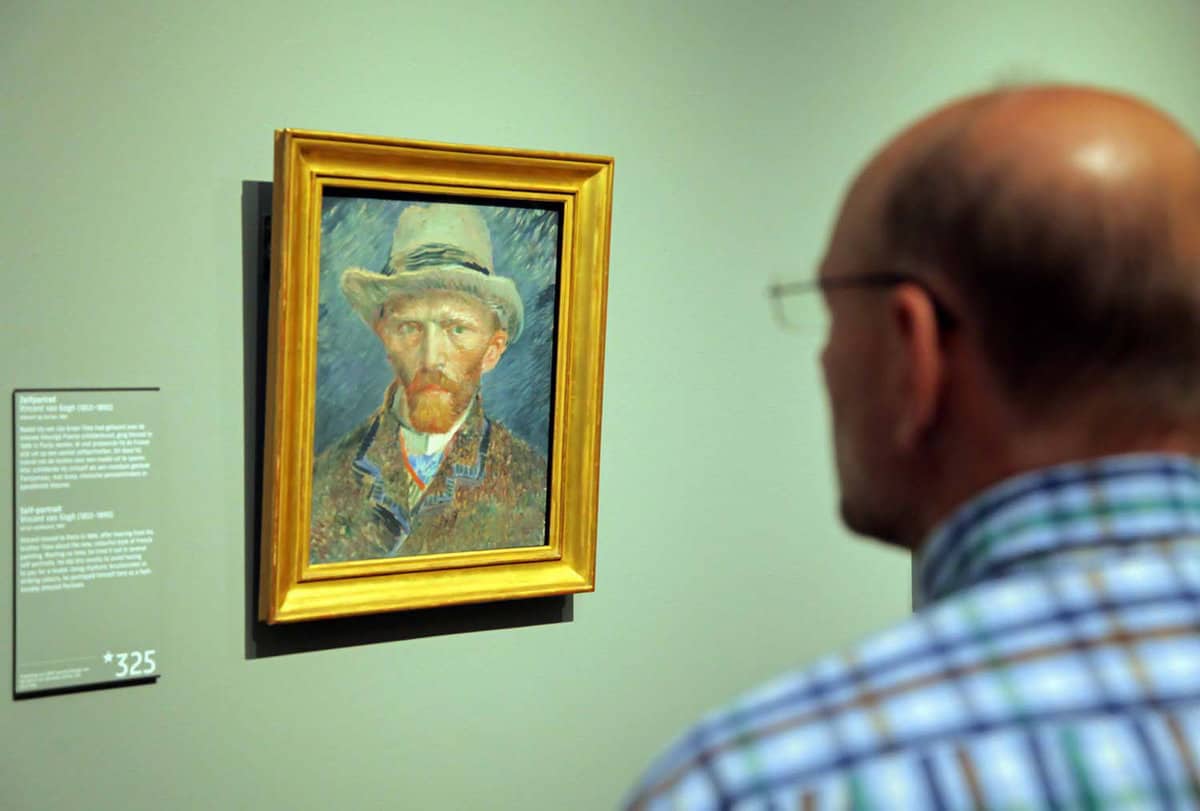 close up of visitor viewing a painting of van gogh