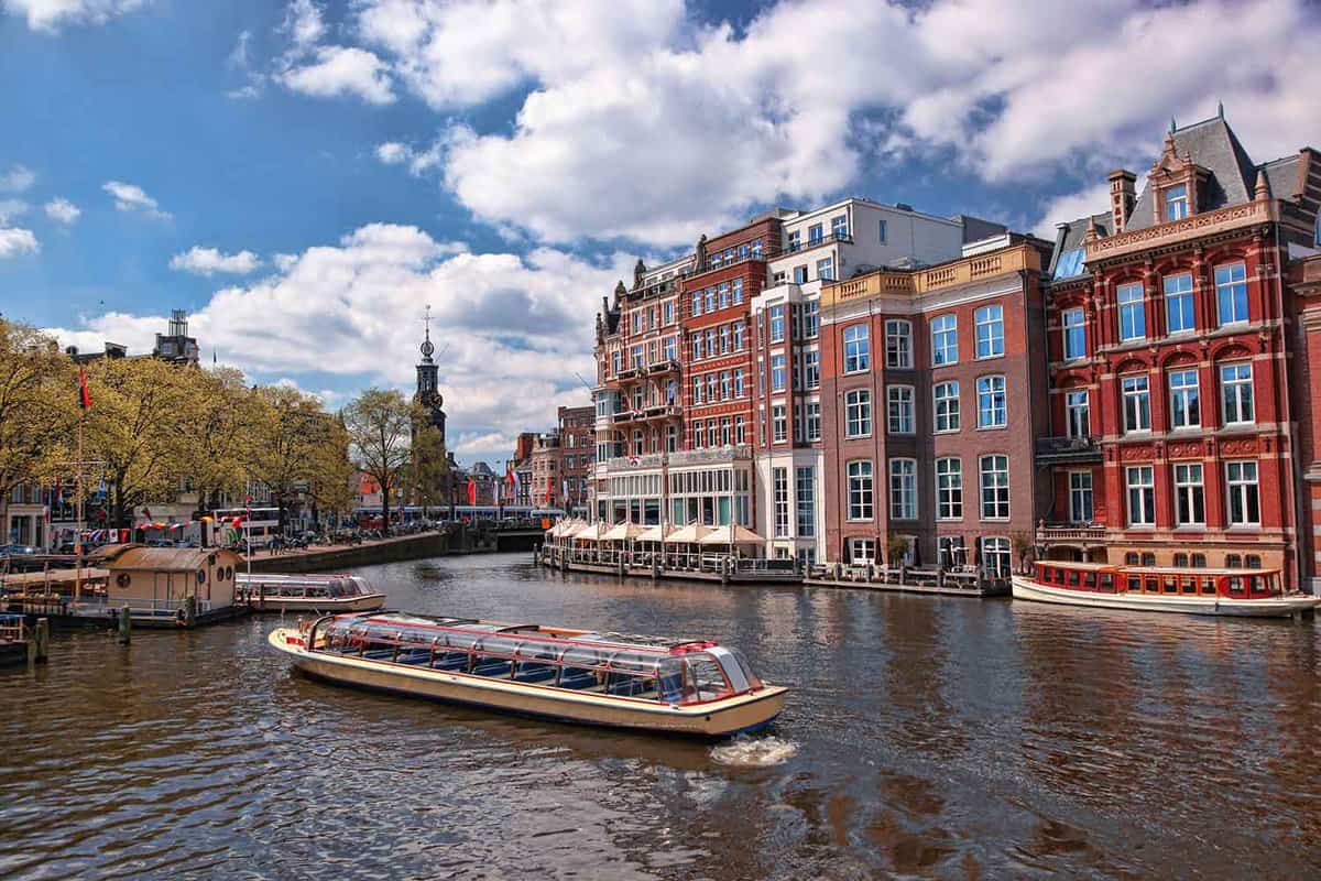 Amsterdam city with boats on canal in city
