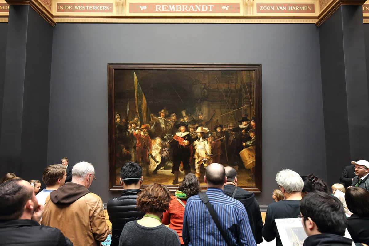 A group of people viewing an art exhibit