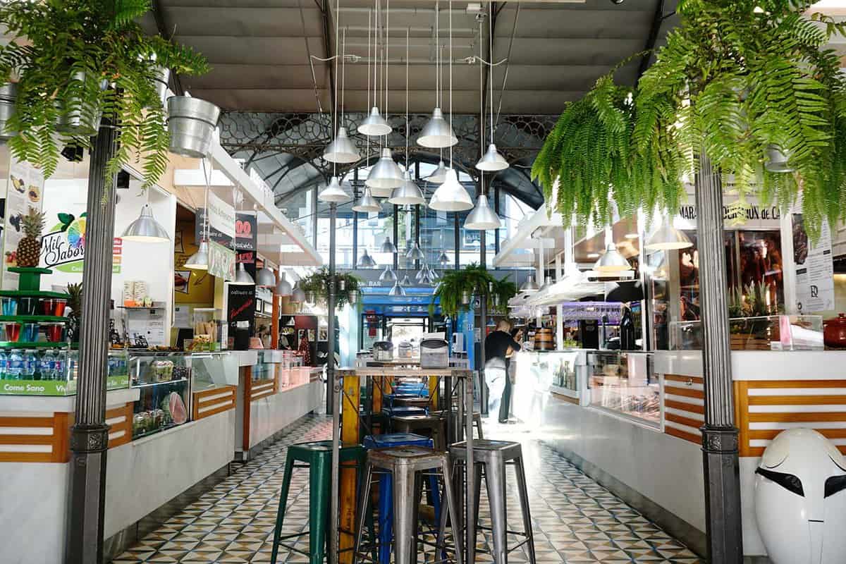 View inside the covered market, where stalls have seating and food on display