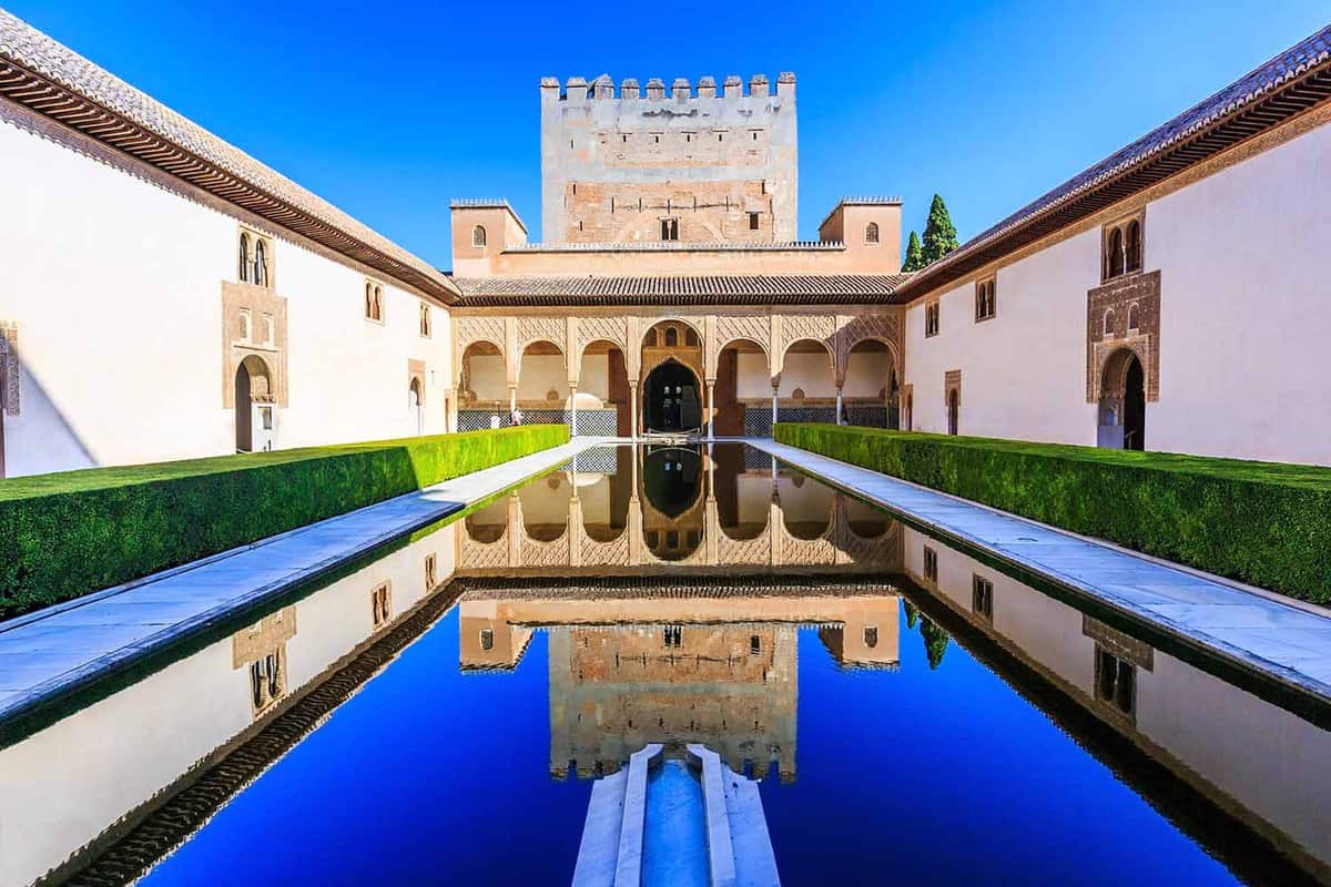 View of a large reflecting pool in front of one of the Nasrid Palace buildings