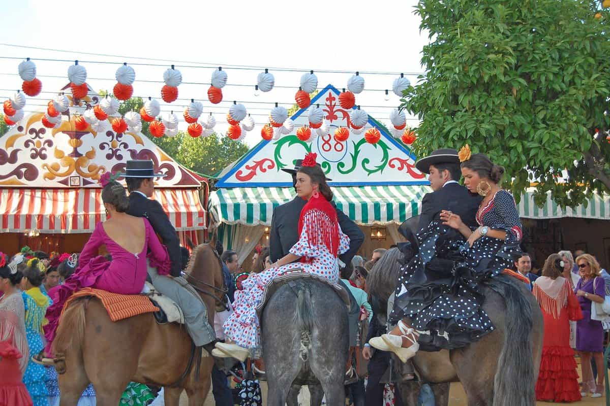 Feria goers sitting astride horses