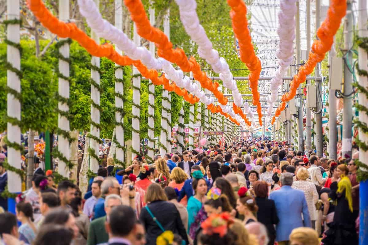 Garlands hand in rows above a crowd of feria goers