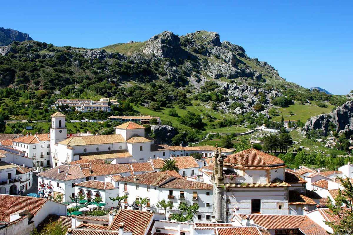 Rooftops of the white village with craggy hill behind