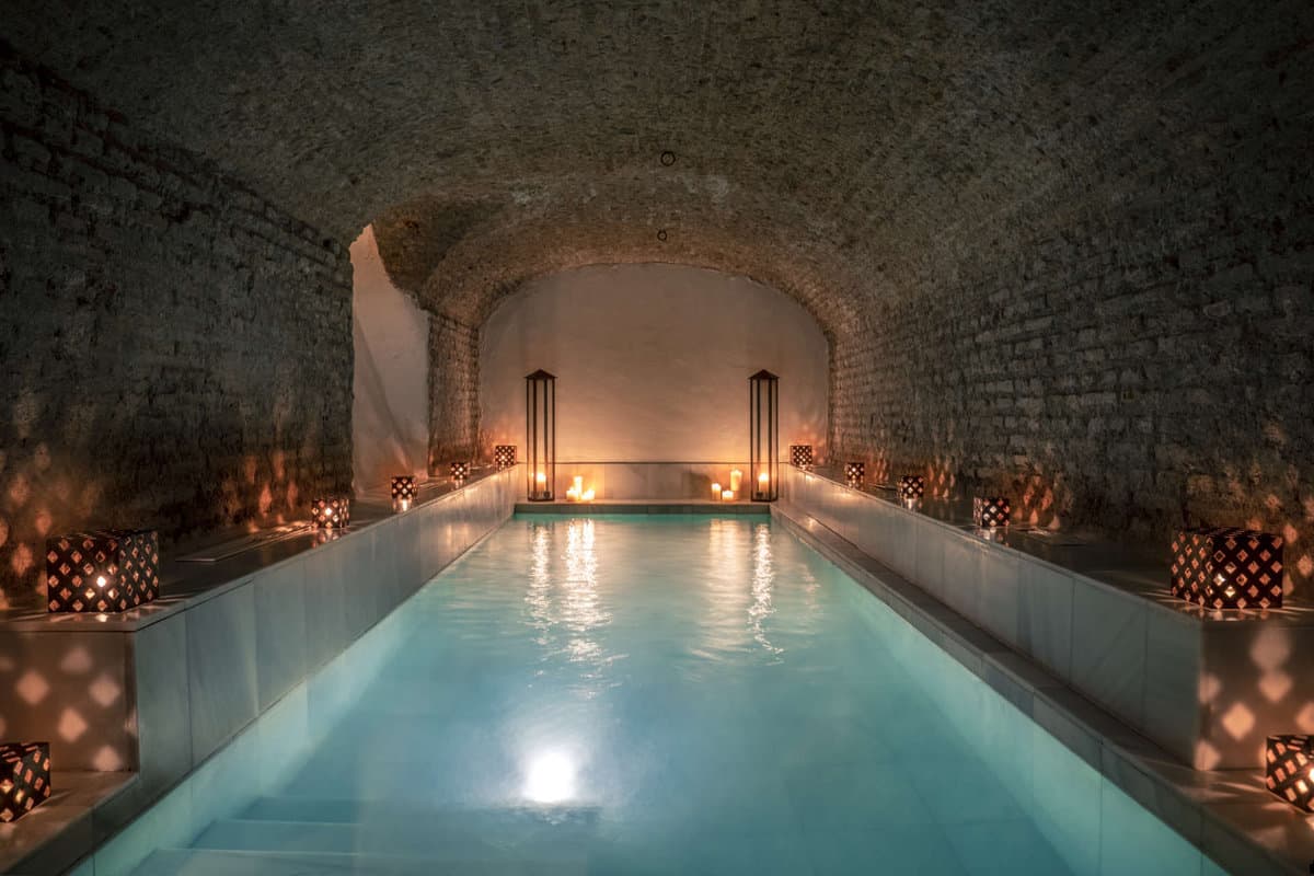 Soothingly low-lit large pool inside the Hammam