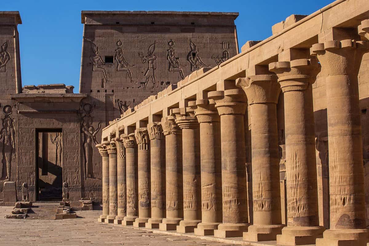 a long columned temple inside the ancient ruins of the Temple of Isis at Philae