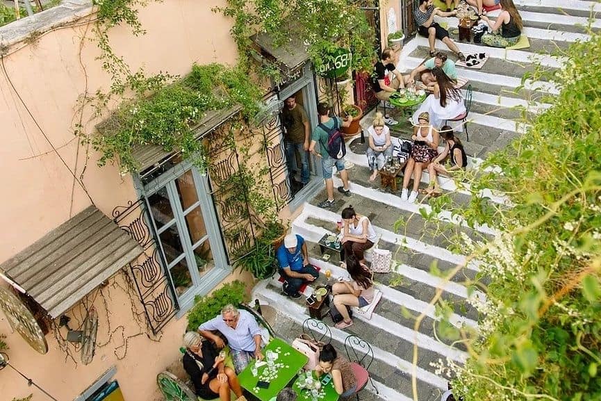People sat on steps outside of Yiasemi cafe in Plaka