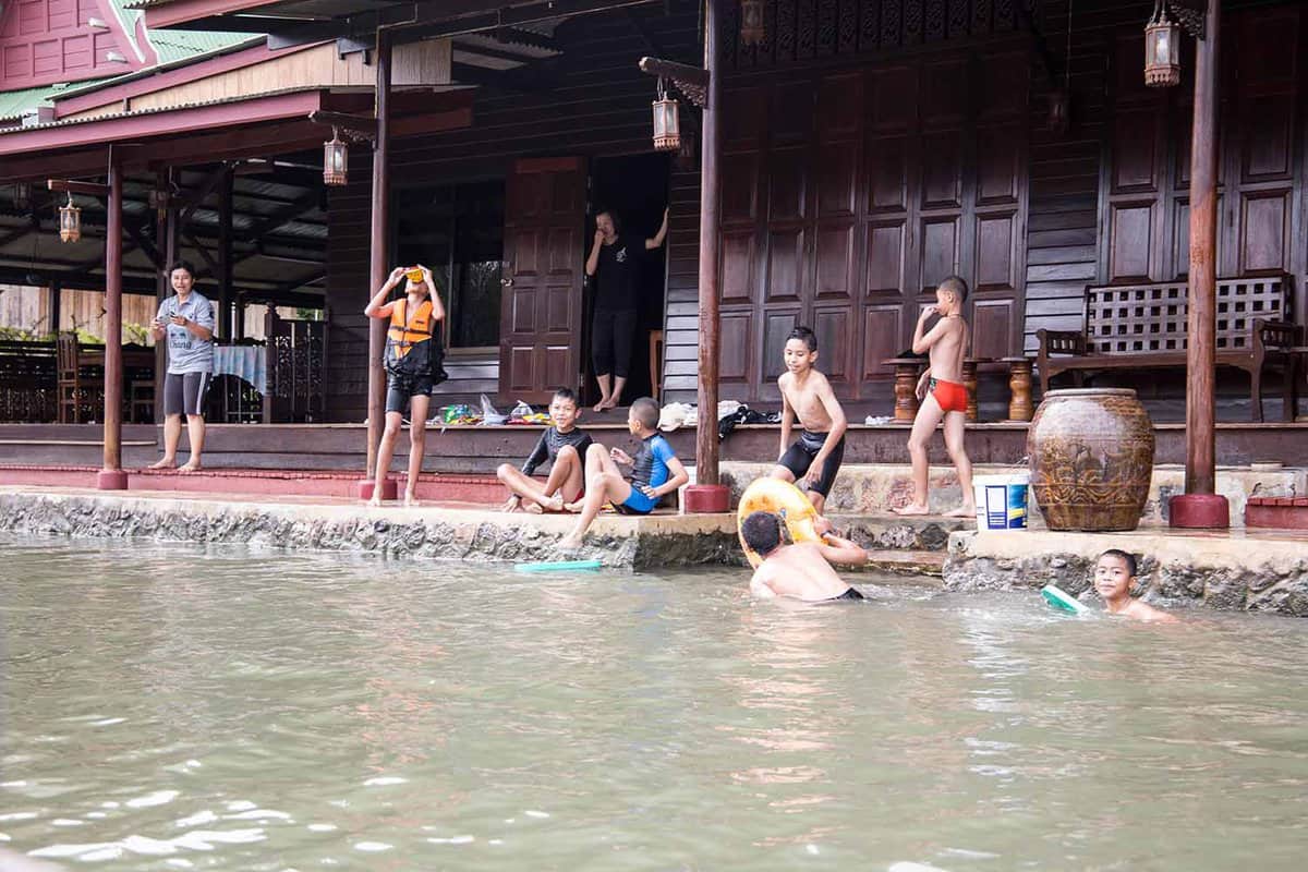 Riverside house with children playing in the water