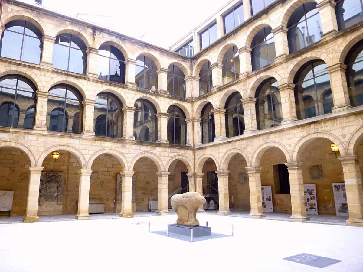 view of a central courtyard surrounded by buildings with arched windows