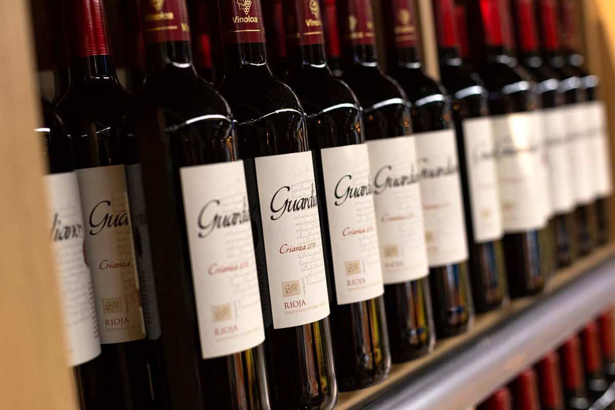 bottles of red Rioja wine on a shelf in a shop