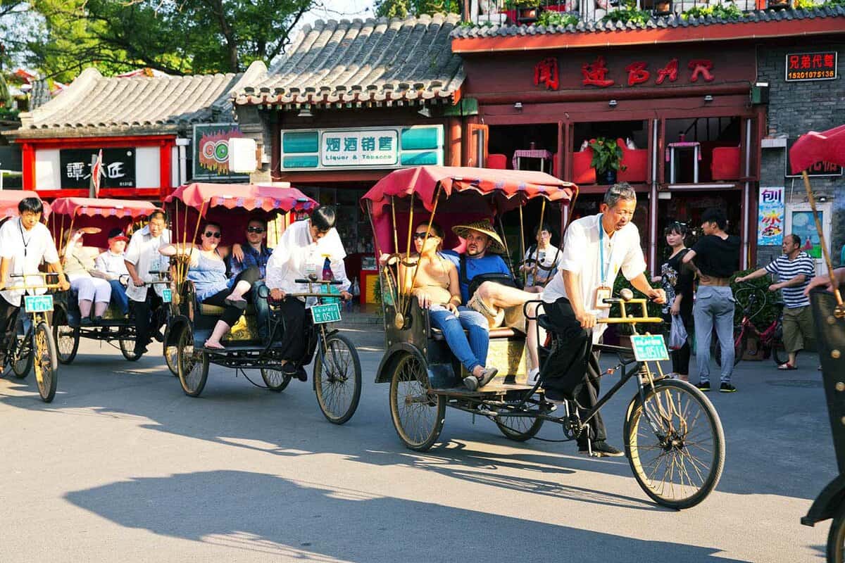 Tourists in rickshaws on sightseeing tours of Beijing's hutongs