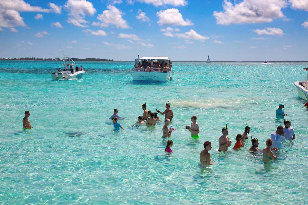 Unidentified people visiting Stingray city on Gran Cayman