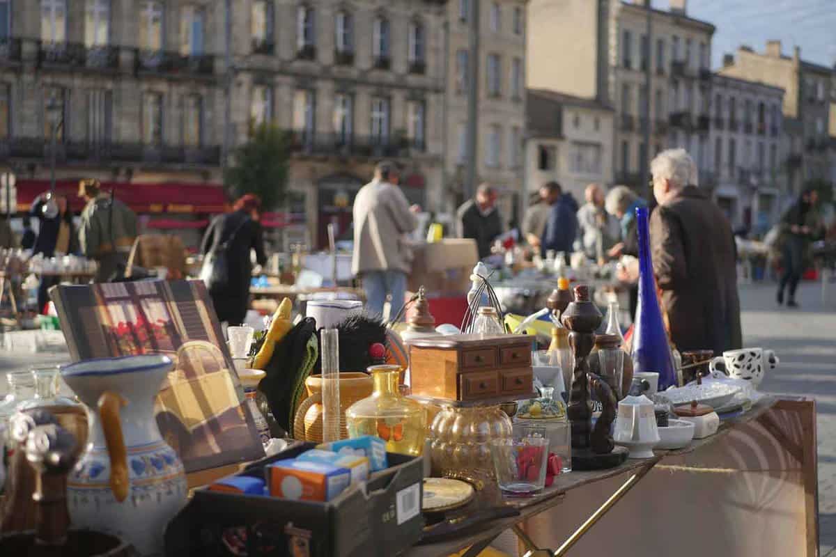 Close up of a table of bric-a-brac, with market faded behind