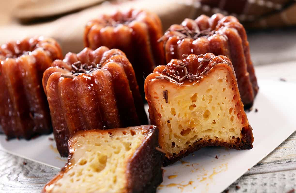 A plate with caneles cakes on it