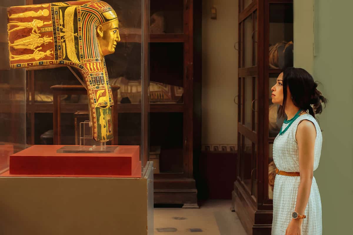 Tourist staring at a golden funerary mask