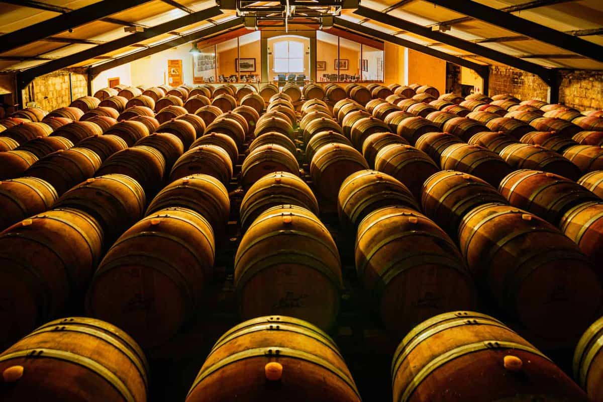 Cellar filled with stacked wine barrels