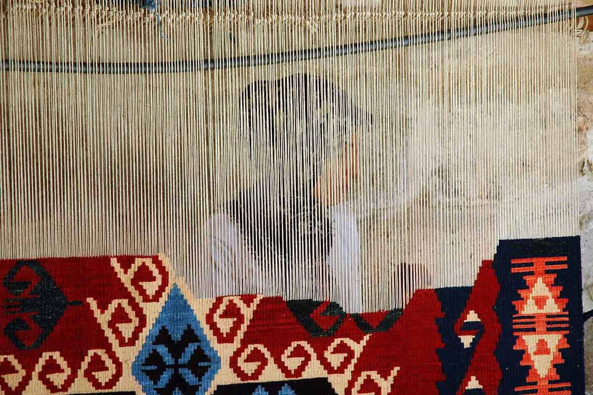 looking trhough a loom Woman in Avanos making a carpet
