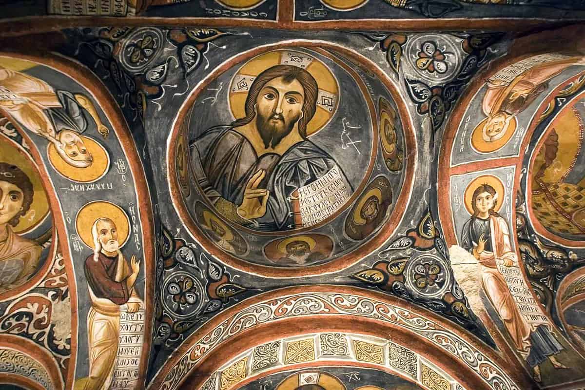 A painting of Jesus on the ceiling of a church.