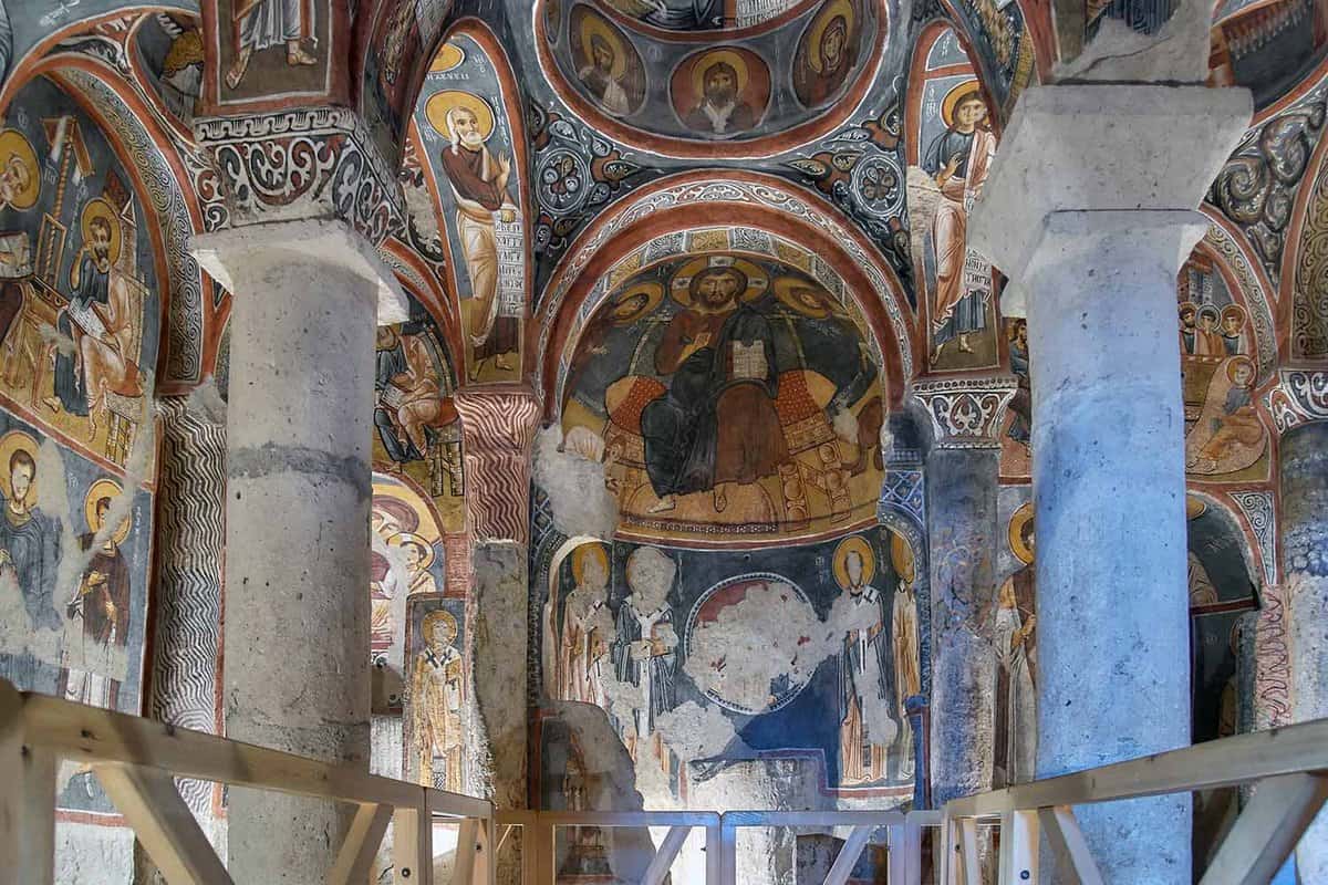 An intricately painted Church with arches on either side.