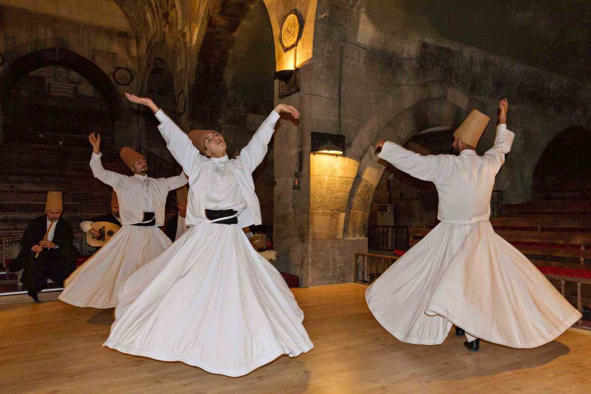 Whirling dervishes perform in an old caravansary in Nevsehir, Turkey.