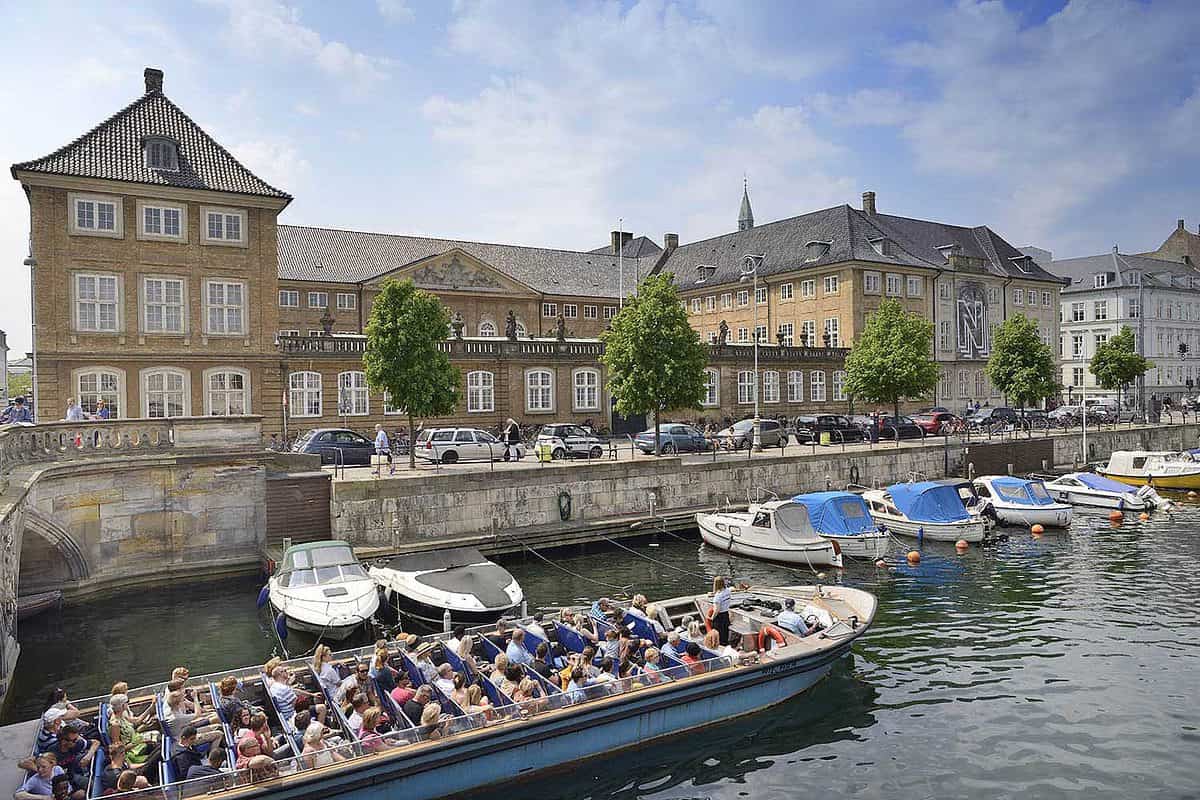 tourists canal boat passing the Danish parliament in copenhagen