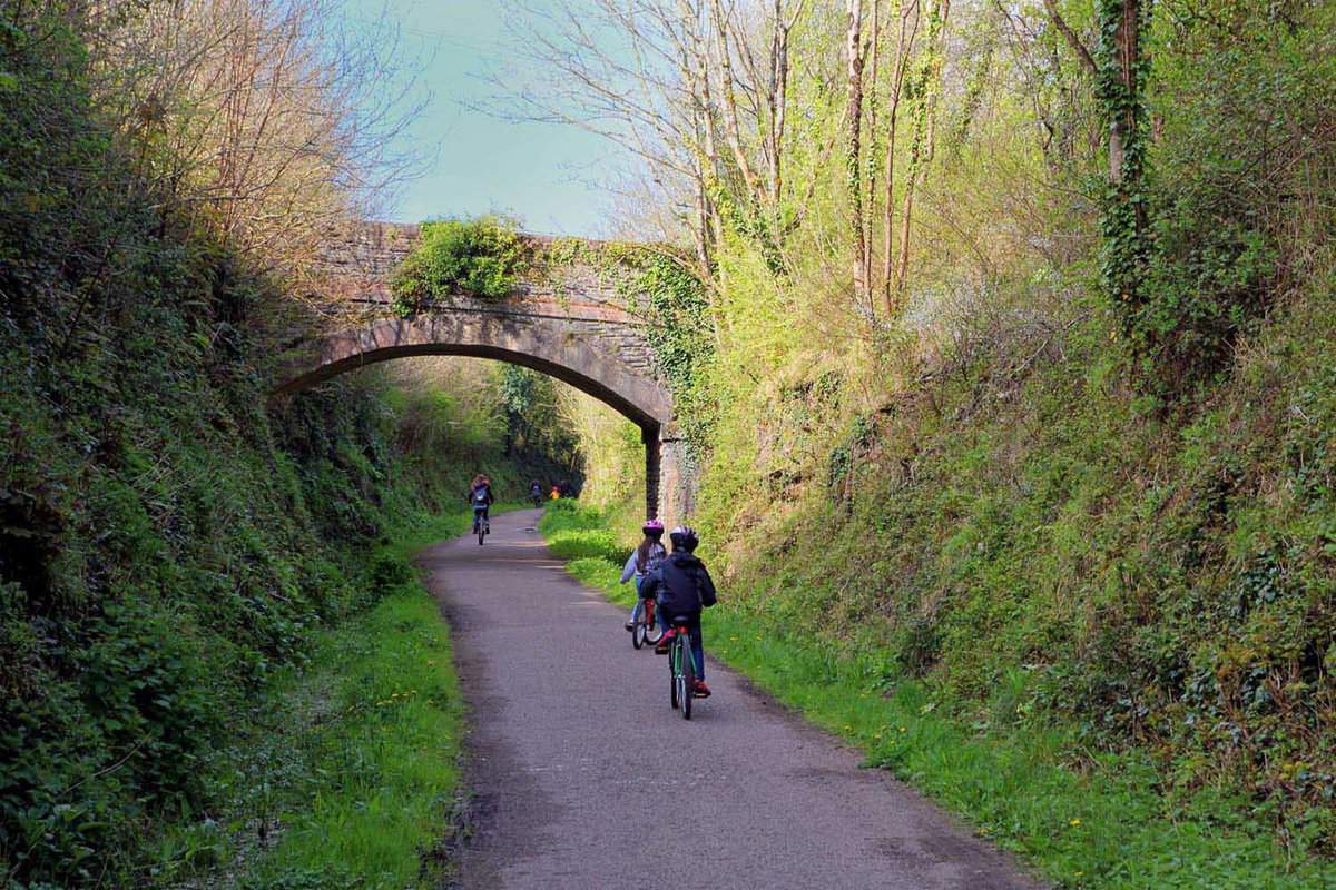 Cyclists riding along the Camel Trail from Wadebridge to Padstow in Cornwall, England