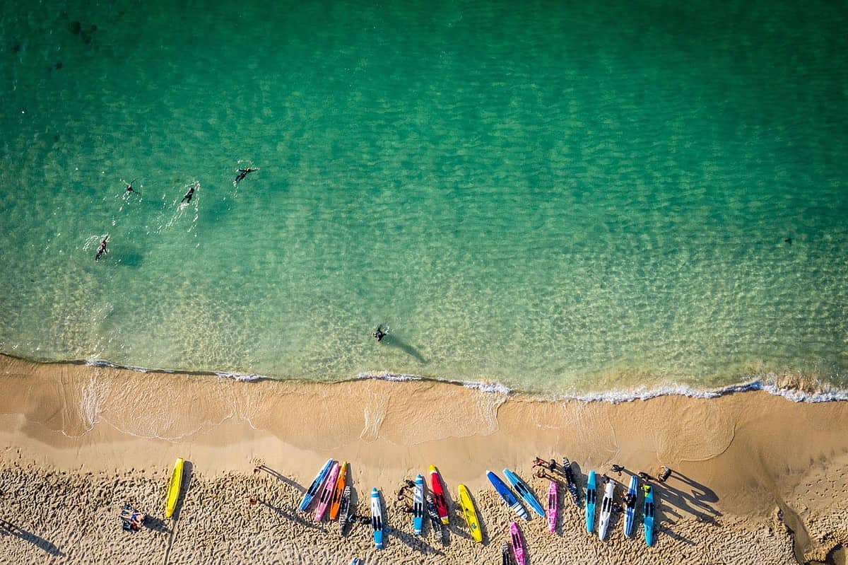 Aerial Image of cornish beach with Paddle boards lined up