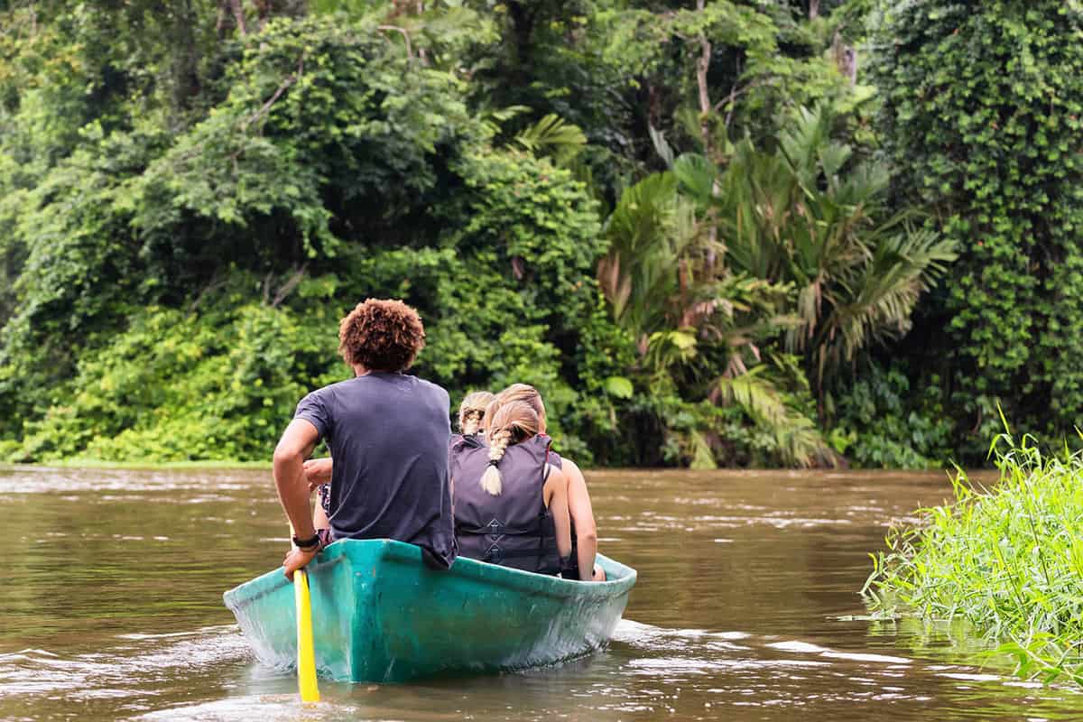 a group on the water in Corcovado National Park in a small green canoe