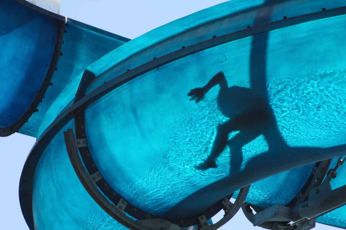 Small child riding down a waterchute from underneath, at Marineland