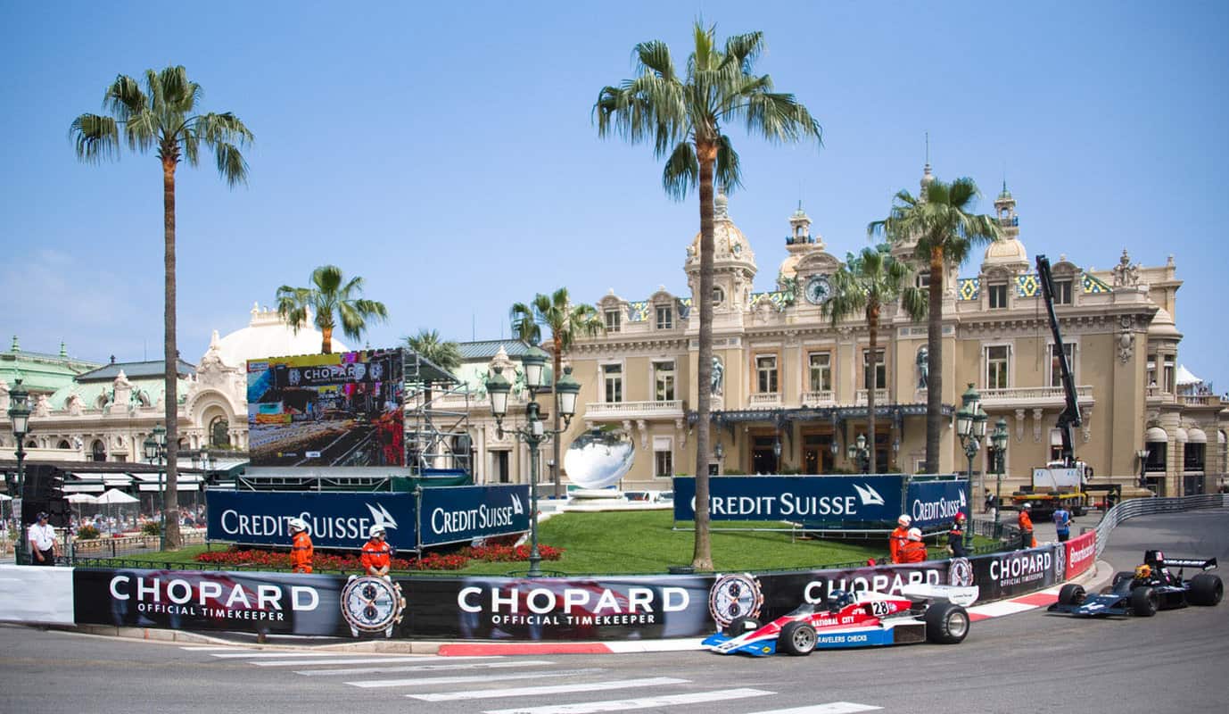 Formula one car driving around corner in city street infront of Casino Monte Carlo