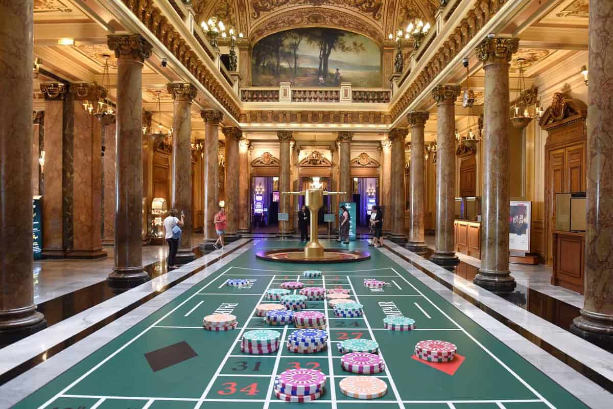 The ornate interior of the Casino Monte Carlo, with roulette table in foreground