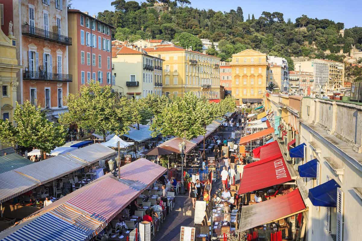 View down between stall awnings of the Cours Saleya market