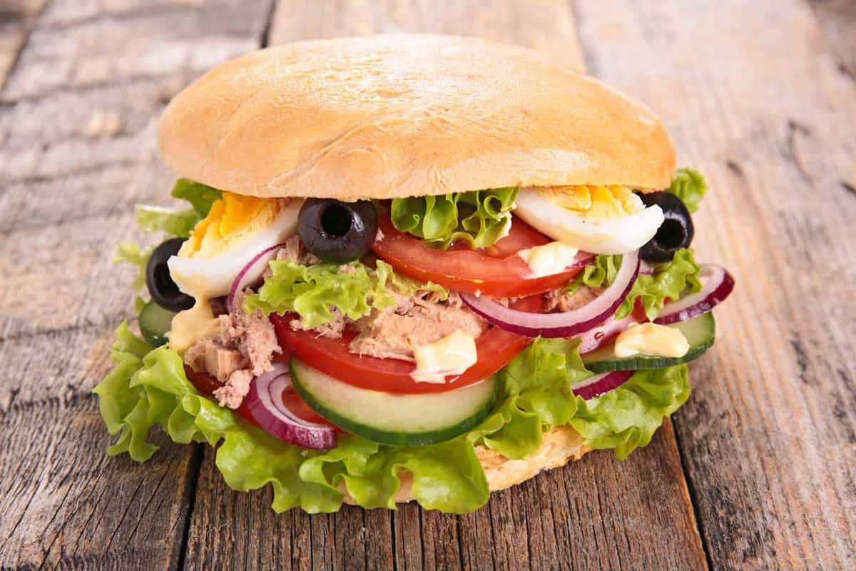 White-bread sandwich with tuna, eggs and salad inside