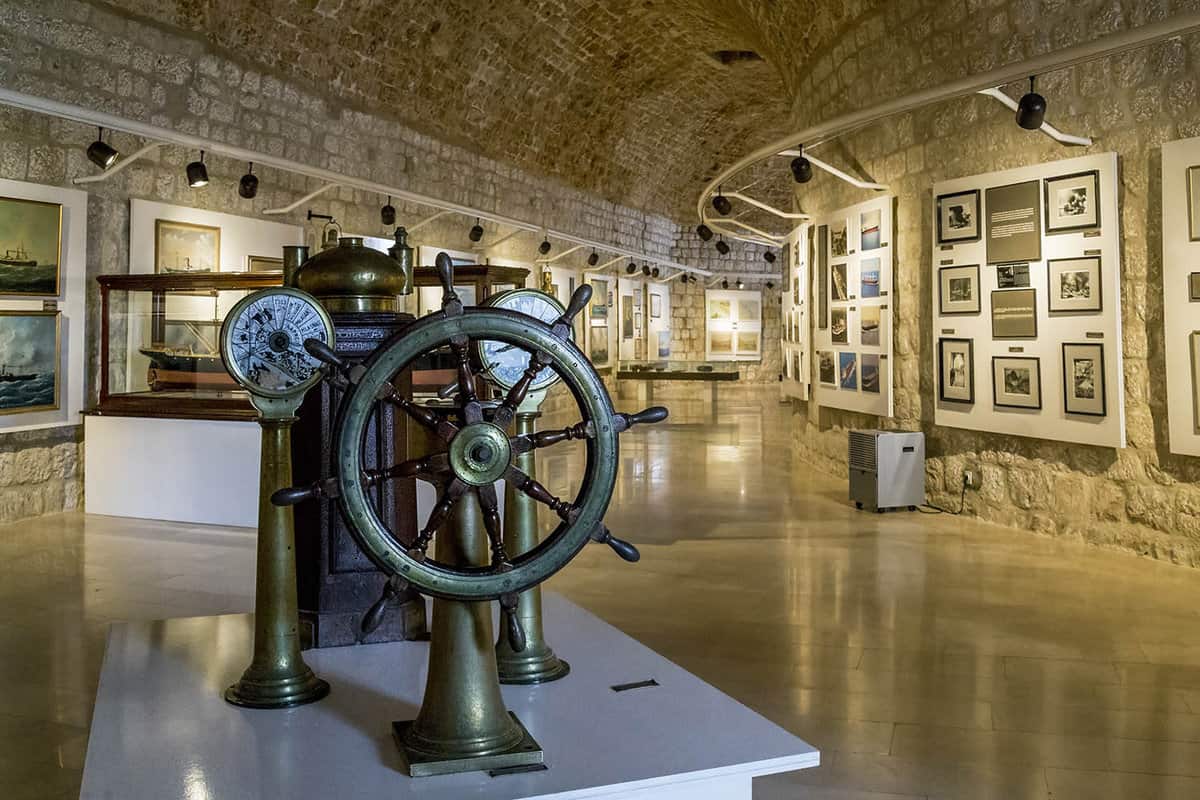 Inside the museum. Ship's wheel in foreground