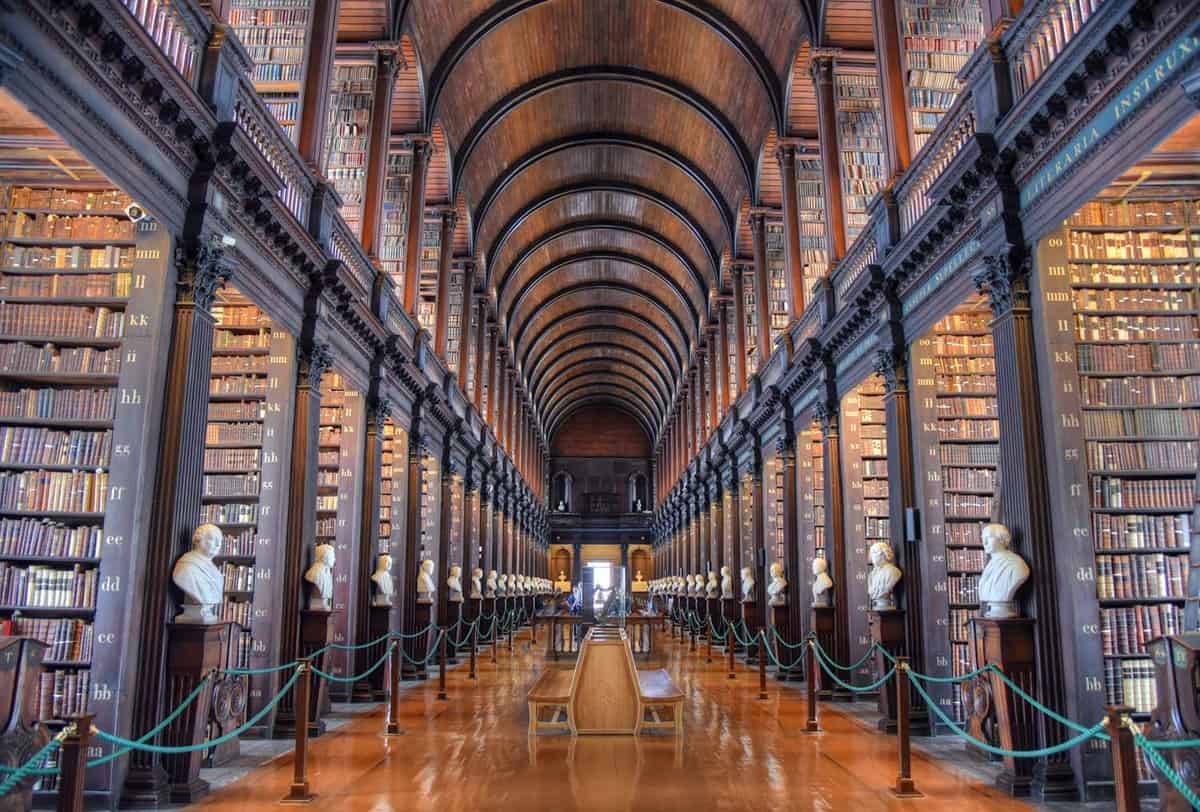 View looking down the long room in the library with millions of books on shelves on either side