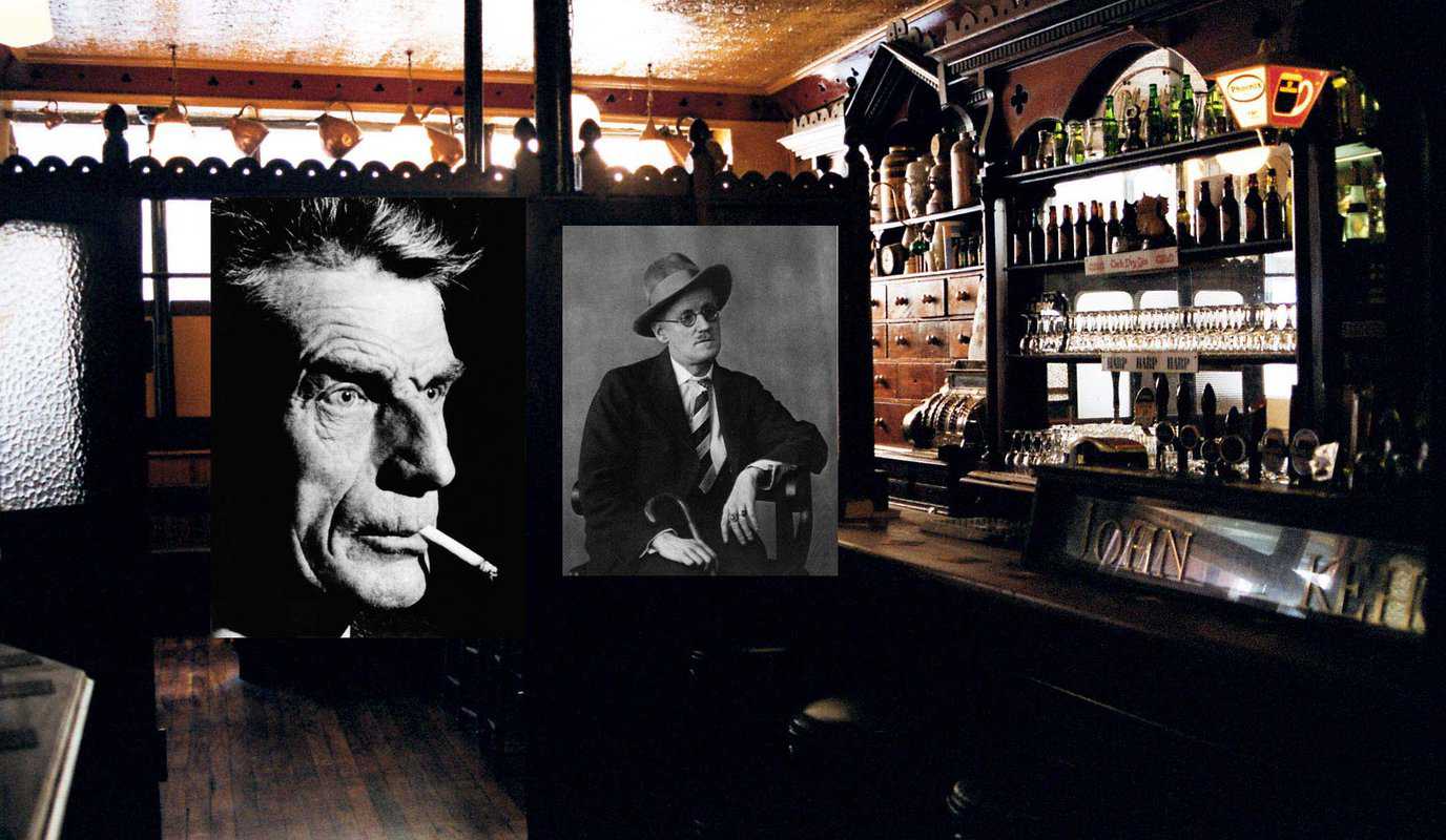 Two black and white portrait photographs hang in a bar