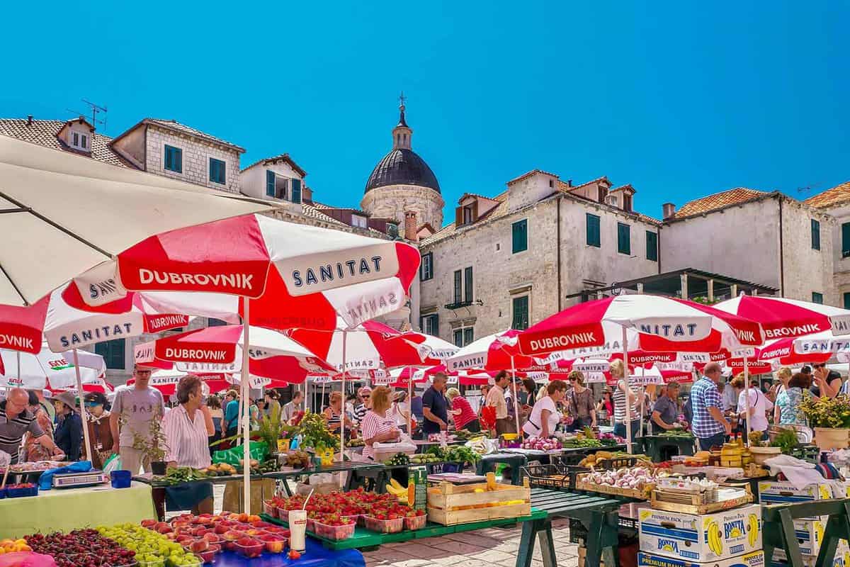 The popular and colorful Dubrovnik Farmers Market in the historical Old Town, featuring outdoor stalls filled with locally grown, fresh produce.