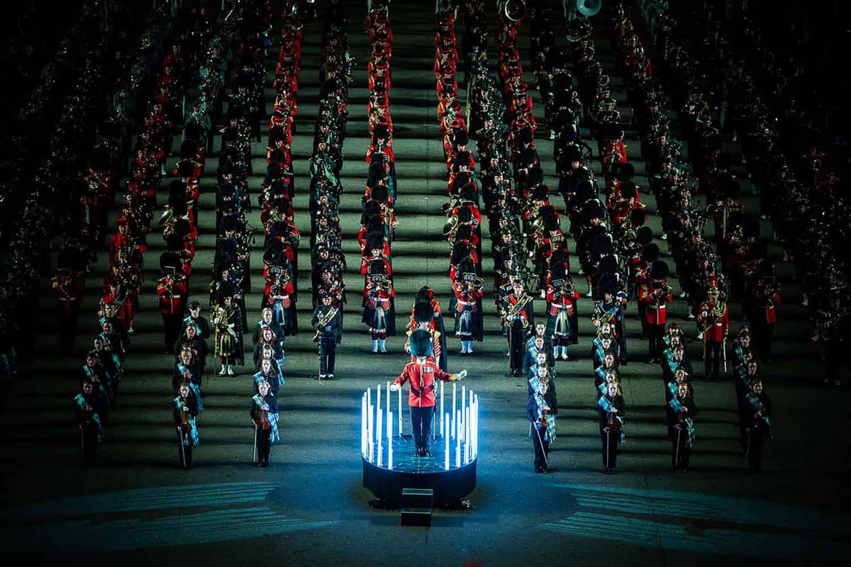 marching band with the conductor on a moving platform in the centre