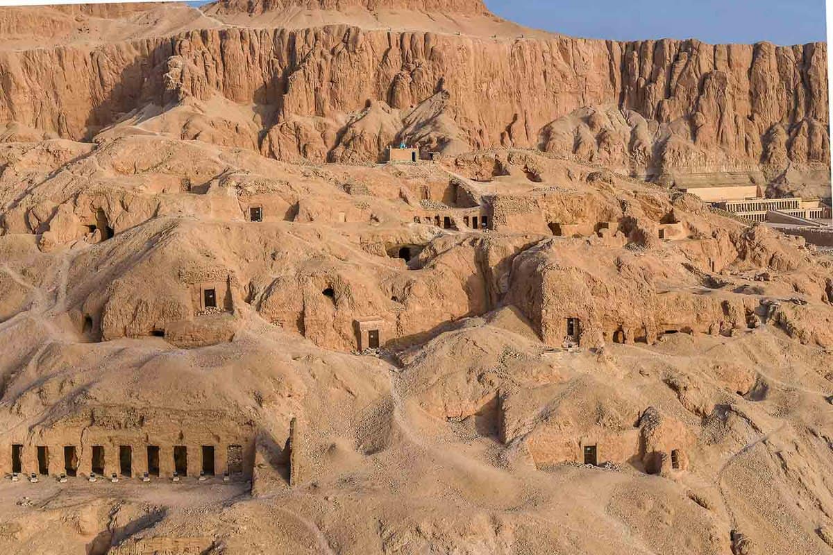 A landscape of desert rocks and hills with small entrances in The Valley of the Queens