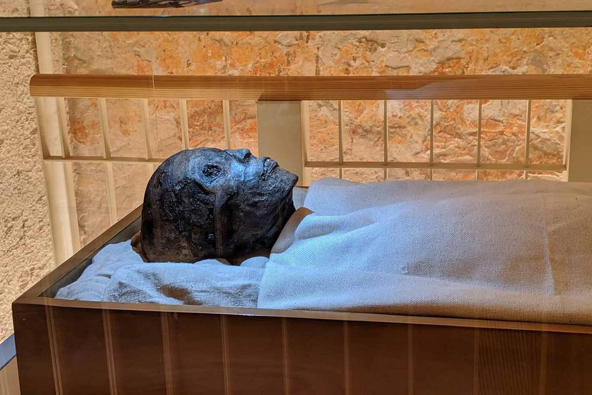Close up of the face of the Mummy of King Tutankhamun, laying at rest in his tomb