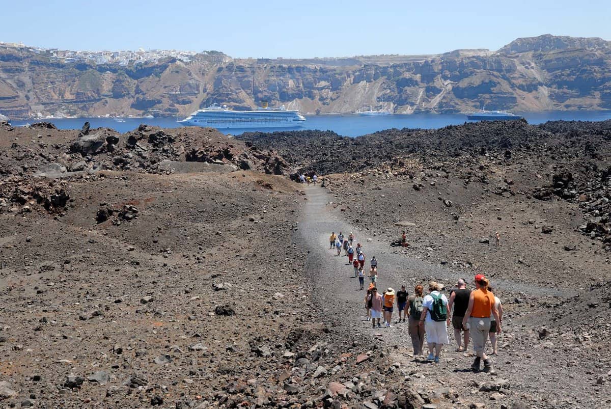 Tourists hiking on the volcanic island Nea Kameni