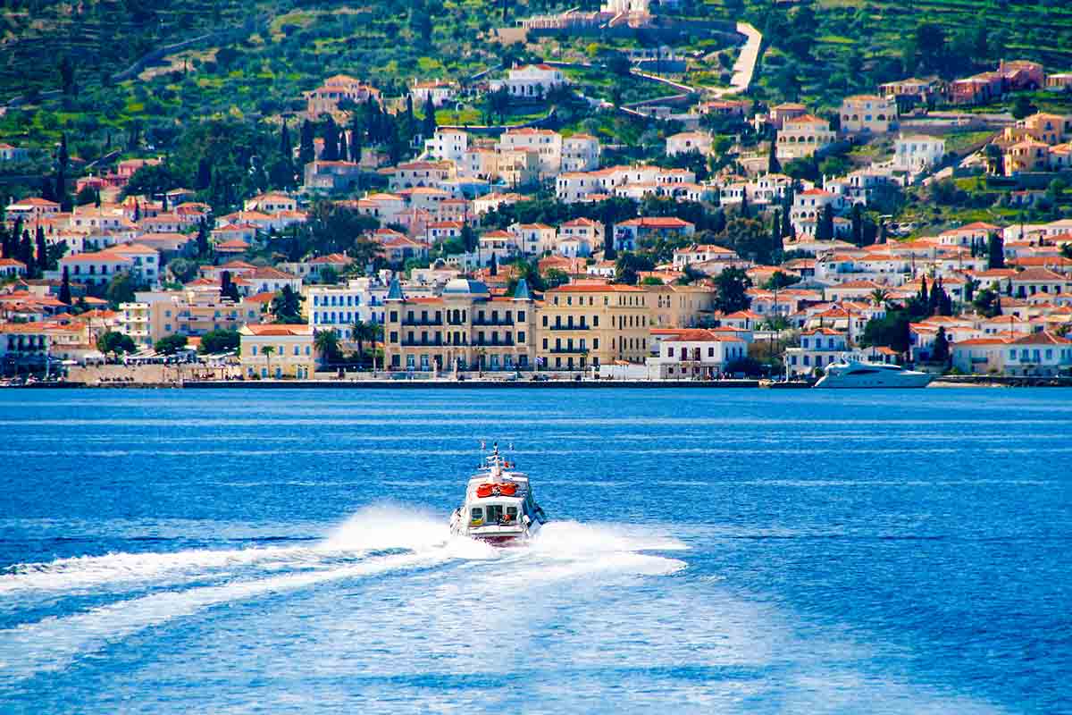 Small red motor boat transfer people to Spetses island, Greece