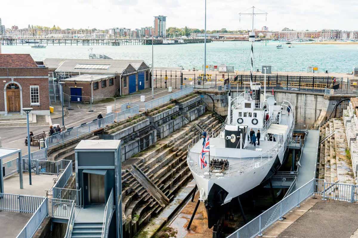 A wide angle of the HMS M33 Royal Navy warship in the First World War showing at Portsmouth Historic Dockyard Museum. The dockland and Portsmouth bridge can be seen in the background of the photo.