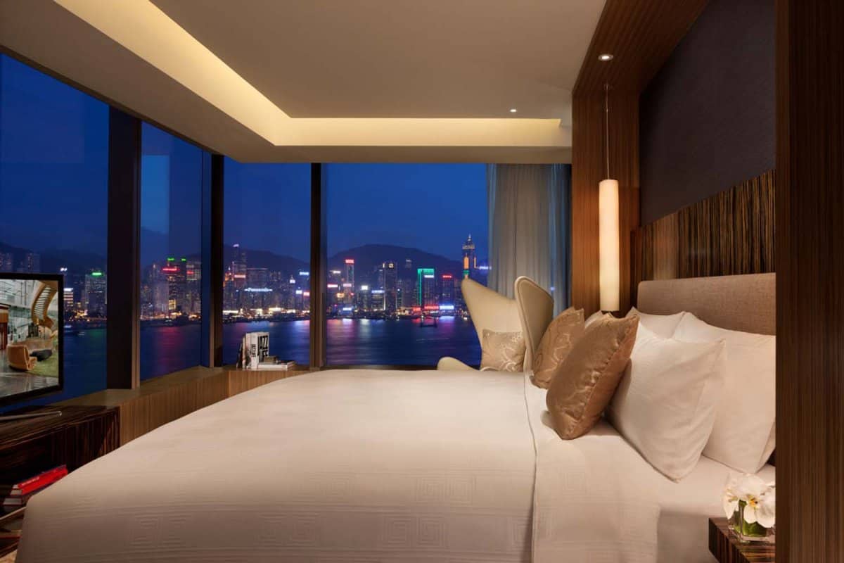 Bedroom with a view of the city at night