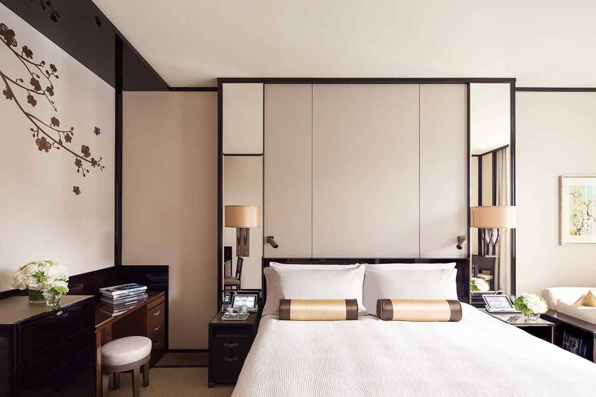 Chic bedroom with panelling behind the bed