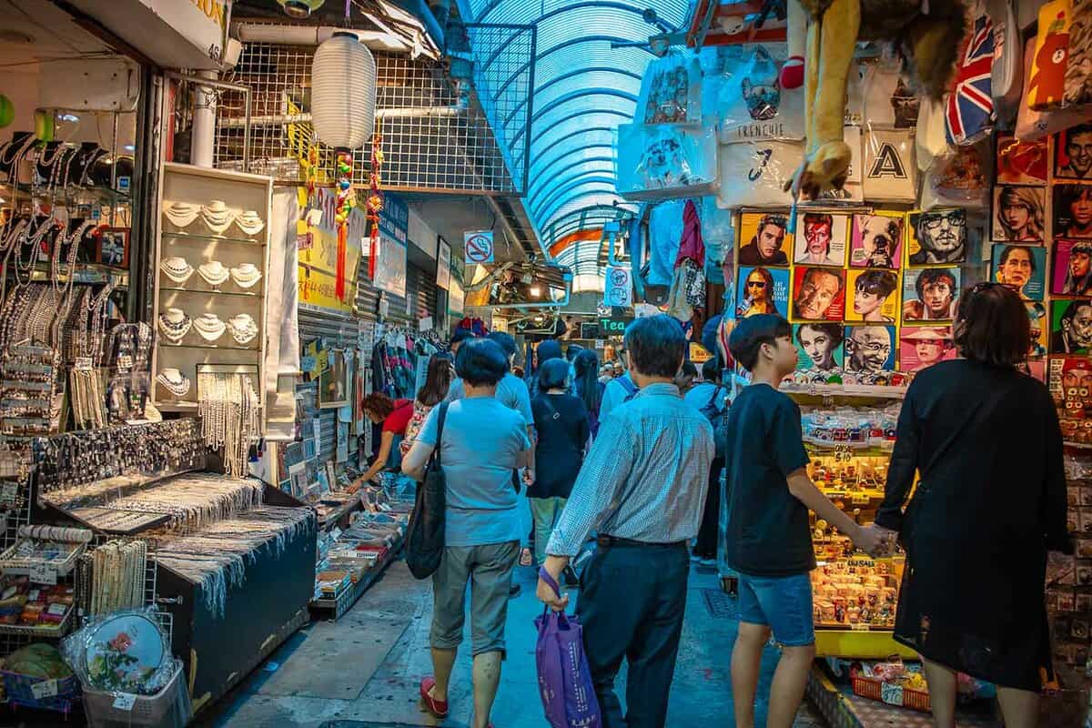 Inside the market, tourists and locals alike look at the different shops and stalls